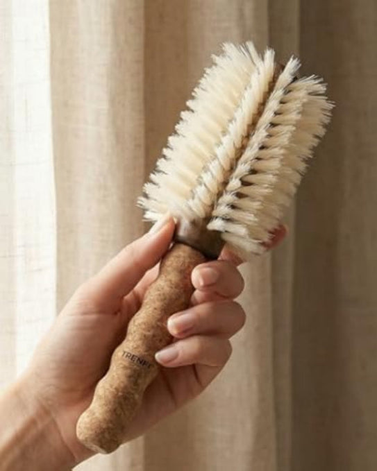 boar-bristle-round-brush being held by someone to blow out their hair  