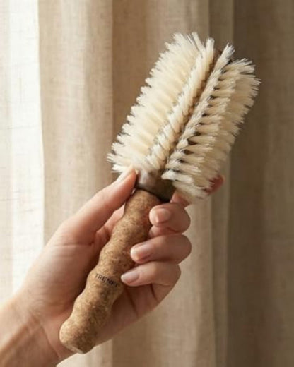 boar-bristle-round-brush being held by someone to blow out their hair  