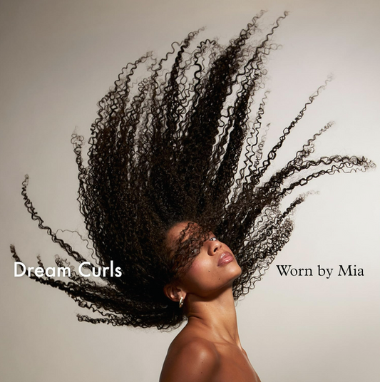 Woman with voluminous curly hair against a plain background, with text 'Dream Curls '.